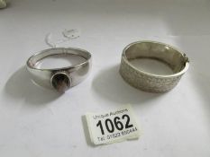 A silver bangle set large stone and one other silver bangle.