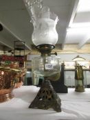 A Victorian oil lamp with later shade.