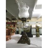 A Victorian oil lamp with later shade.