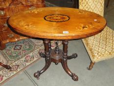 A Victorian mahogany oval inlaid loo table.