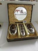 A set of 3 Edwardian silver and tortoise shell hair brushes in case.