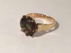 A 9ct gold round smoky quartz ring, hall marked Birmingham 1978. Size P.