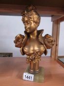 A heavy metal bust of a lady.