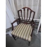 A mahogany shield back elbow chair.