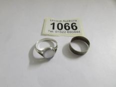 A silver ring and a white metal ring.
