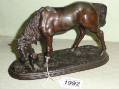 A spelter horse with dog.