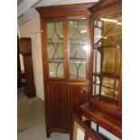 An Edwardian mahogany inlaid corner cabinet.