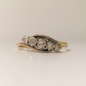 An 18ct gold and platinum 1940's 5 stone diamond ring fashioned as a twist, size P.