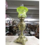 A Victorian bras soil lamp with yellow glass shade.