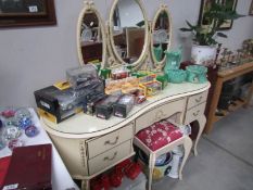 A triple mirror dressing table and stool.