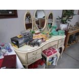 A triple mirror dressing table and stool.