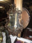 An unusual brass surround wall mirror.