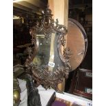 An unusual brass surround wall mirror.