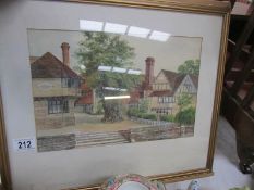 A framed and glazed watercolour village scene signed F R Hodson, 1948.