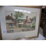 A framed and glazed watercolour village scene signed F R Hodson, 1948.