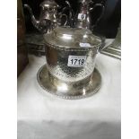 A silver plate biscuit barrel.