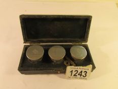 A cased set of 3 silver pill boxes.