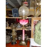 A Victorian pink cranberry Corinthian column oil lamp.