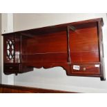 A mahogany wall shelf.