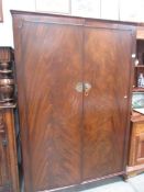 A mahogany wardrobe with brass fittings,.