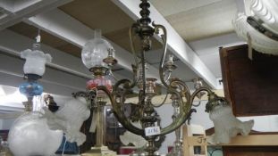An antique 3 lamp brass ceiling light.