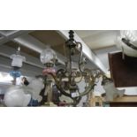 An antique 3 lamp brass ceiling light.