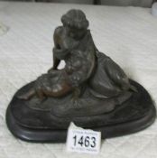 A spelter figure of mother and child.