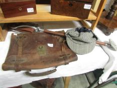 A vintage gamebird shooting stick, a tweed deer stalker hat and a leather briefcase.