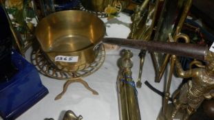 A Victorian brass saucepan on trivet.