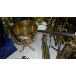 A Victorian brass saucepan on trivet.