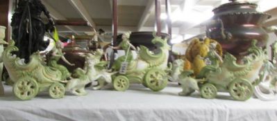 A set of 3 continental porcelain chariots with riders and pulled by wild cats.