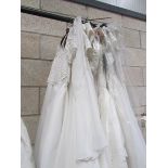 Approximately 12 wedding gowns in various sizes.