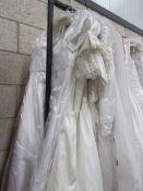 Approximately 11 wedding gowns in various sizes.