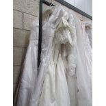 Approximately 11 wedding gowns in various sizes.