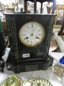 A black marble mantel clock.