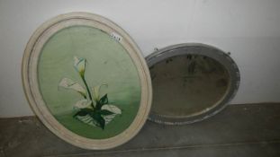 An oval painting and a mirror,.