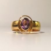 A 22ct gold ring set with oval amethyst, hall marked Birmingham 1918, size N.