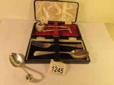 A cased silver fork & spoon, a cased silver spoon with pusher and one other silver spoon,.