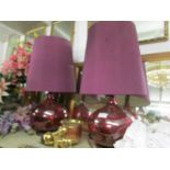 A pair of impressive red glass table lamps with shades.