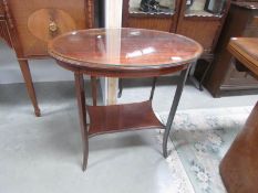 An oval inlaid occasional table with glass protective top.