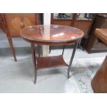 An oval inlaid occasional table with glass protective top.