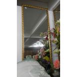 An oblong gilt framed mirror.