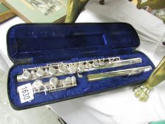 A cased silver plated flute marked Amati Kruzliz.
