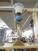 A brass Corinthian column oil lamp with vaseline glass shade.