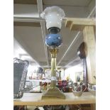 A brass Corinthian column oil lamp with vaseline glass shade.