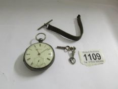 A silver pocket watch, wound to maximum.