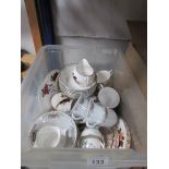 A box of assorted tea ware.