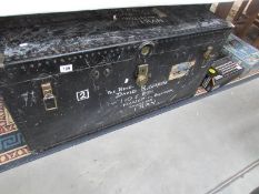 A large cabin trunk with brass lock.