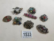 8 good stone set brooches.