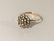 A yellow gold floral dress ring, size X.